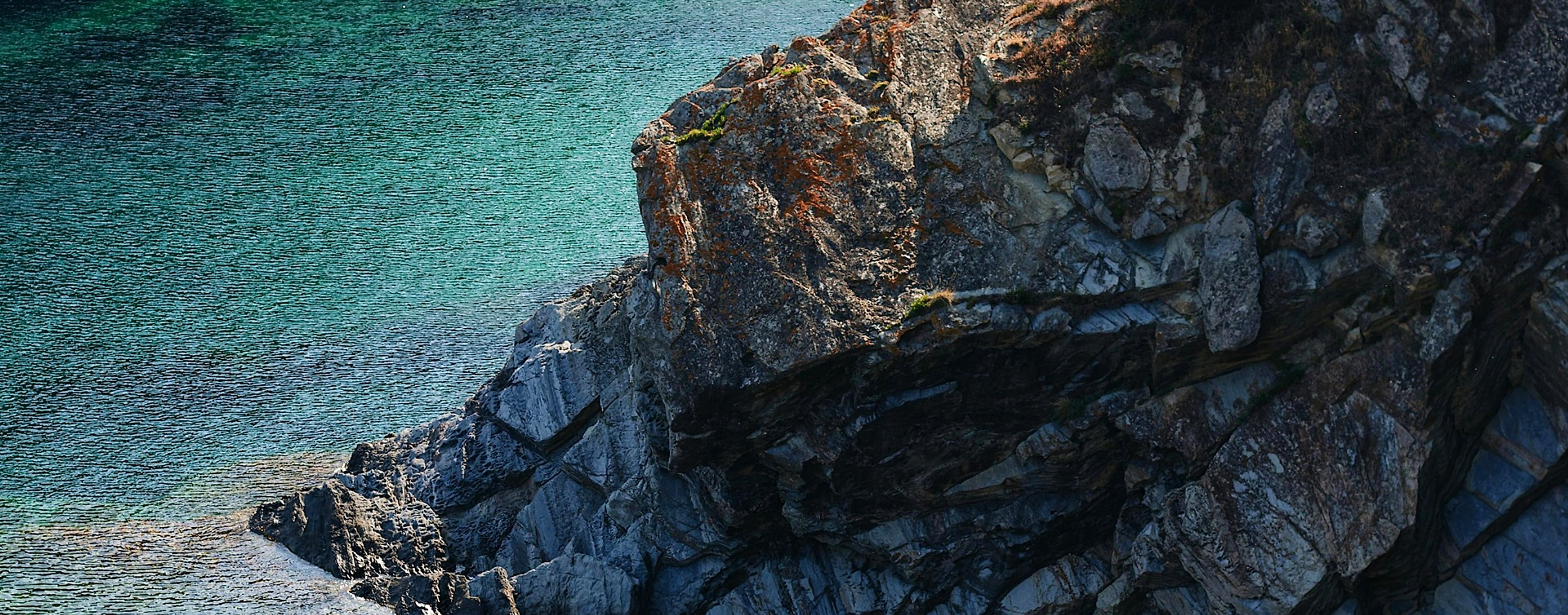 A rugged coastal cliff meeting the sea — a durable, protective legal foundation